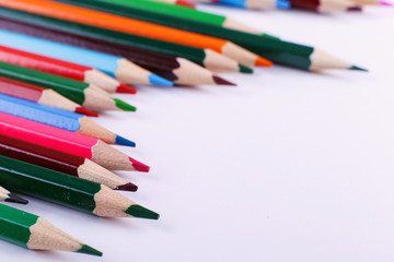 Colored pencils, on white background, pattern, copy space.