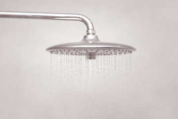 Rain Shower turned on, ceiling shower head closeup in the shower stall.