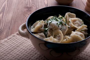 Homemade dumplings with sour cream.