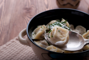 Homemade dumplings with sour cream.
