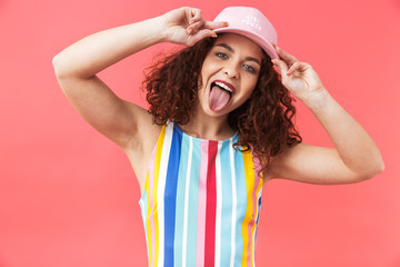 Portrait of a cheerful young woman wearing cap