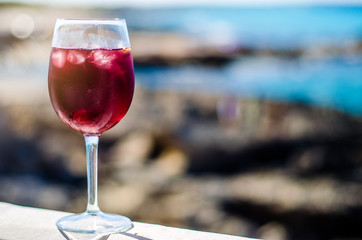 Glass of sangria by a sea bar
