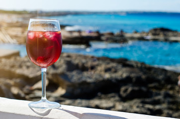 Glass of sangria by a sea bar
