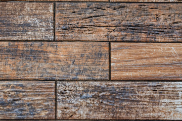 Dark wooden planks covering floor close up background