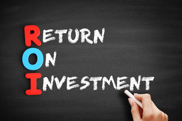 Color Wooden alphabets building the word ROI - Return On Investment acronym on blackboard