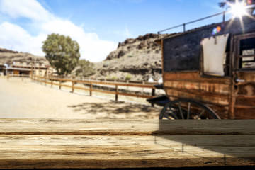 Fototapeta na wymiar Wooden old table of free space and Wild West background 