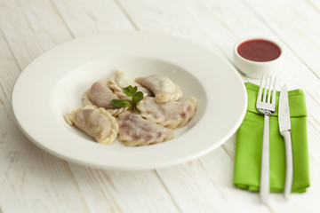 dumplings with potatoes on a white plate