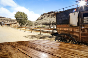 Wooden old table of free space and Wild West background 