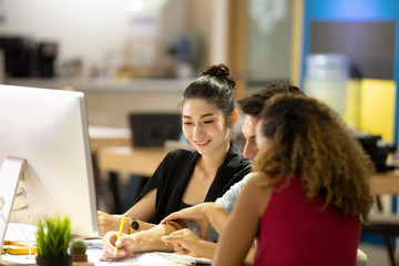 Successful team at work. Group of young business people working and communicating together in creative office