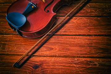 The abstract art design background of wooden violin and bow put on wooden timber board,blurry light...