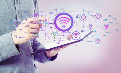 Wifi concept with man holding a tablet