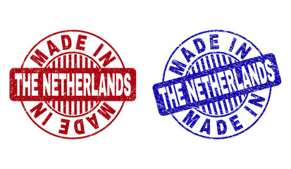 Grunge MADE IN THE NETHERLANDS round stamp seals isolated on a white background. Round seals with grunge texture in red and blue colors.