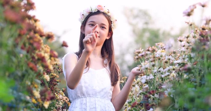 Girls with beautiful flower gardens and bubbles,Long haired girls wear white dresses, are happy with flowers and bubbles.girl with soap bubbles in summer park with blooming flowers