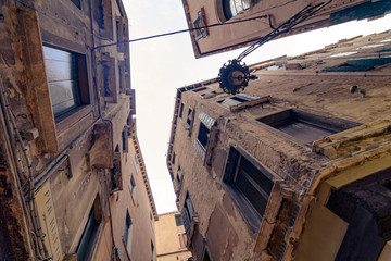 typical narrow alley in street of Venice (Venezia) at a rainy day, vintage style, Italy, Europe