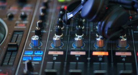 DJ equipment. Player and mixing console with headphones. 