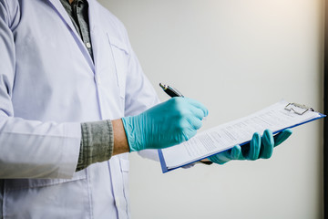 Asian scientist holding report writing make note with reagent laboratory researcher concept.