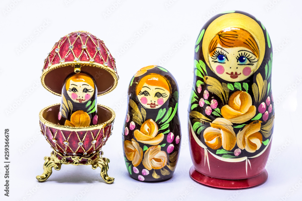 Wall mural Matryoshka family. Matrioska art Russian doll and Russian souvenir, egg casket copy of Faberge on a White background