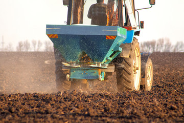 Tractor on the field and makes the fertilizer