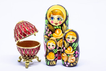 Matryoshka family. Matrioska art Russian doll and Russian souvenir, egg casket copy of Faberge on a White background