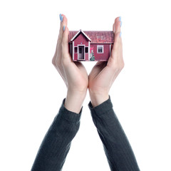 Small house in hand on white background isolation