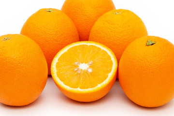 oranges and sliced orange on white background
