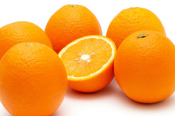 oranges and sliced orange on white background