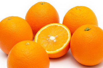 oranges and sliced orange on white background