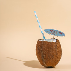 Coconut cocktail in a shell in cup with an umbrella and straw. The concept of tropical holiday,...
