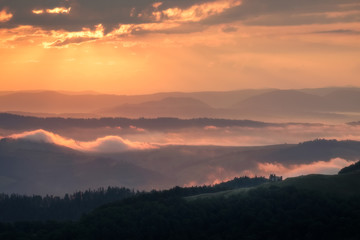 Foggy sunrise in Mountains over alone house. Ukraine, Carpathians, Borjava ridge