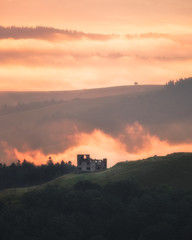 Obraz premium Foggy sunrise in Mountains over alone house. Ukraine, Carpathians, Borjava ridge