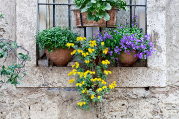 Fototapeta na wymiar Italian window decorated with flowers.