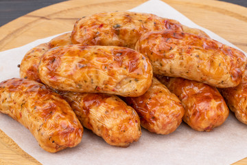 Tasty grilled sausage on the wooden background