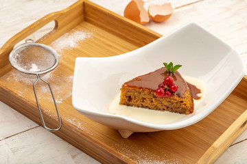 date cupcake on cream in a white plate on a light background, on a wooden tray
