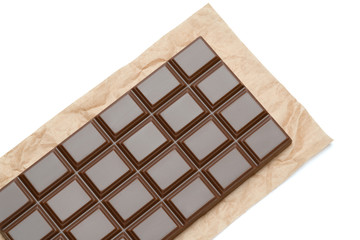 milk chocolate bar on craft packaging paper isolated on white background with clipping path