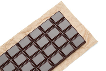 dark chocolate bar on craft packaging paper isolated on white background with clipping path