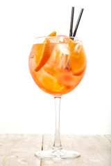 glass of aperol spritz cocktail on white background
