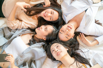 Group of beautiful pretty asian women friend on cozy bed