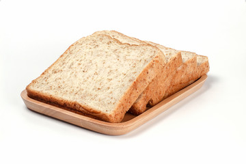 Toast wheat bread sliced on wooden plate isolated on white background