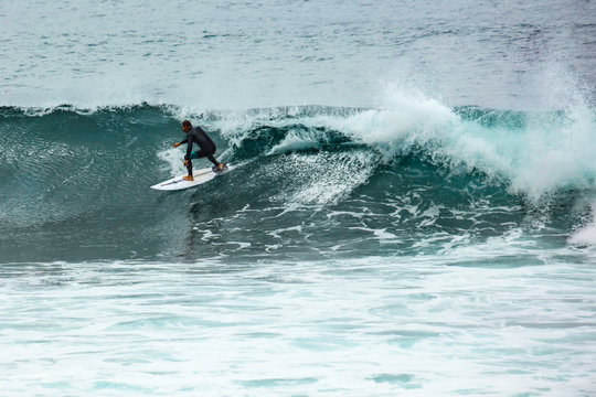 Surfer on beach and ocean landscape 