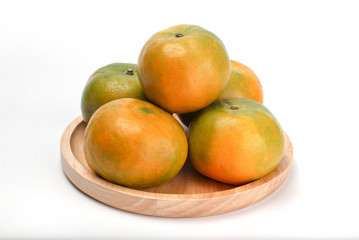 Naklejka na ściany i meble Orange in wooden plate. Orange honeydew Thai fruit white background