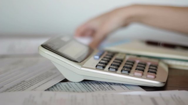 Accountant calculates bills receipts for taxation purposes