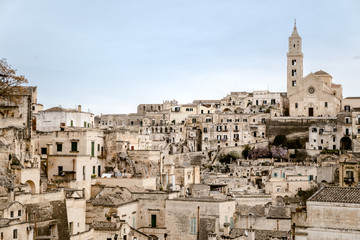 Fototapeta na wymiar Panoramic view of the city of Matera in Italy, ancient curious village for tourists to be built inside the rocks in caves and stone houses, seen from the top.