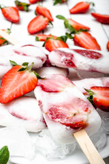 Homemade popsicle, frozen fruit ice cream with strawberry and milk