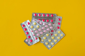 pills located on a yellow background