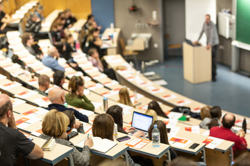 Conference and Presentation. Audience at the conference hall. Business and Entrepreneurship. Faculty lecture and workshop. Audience in the lecture hall. Academic education. Participants making notes.