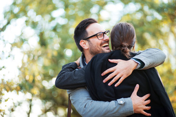 Man hugging his woman at park