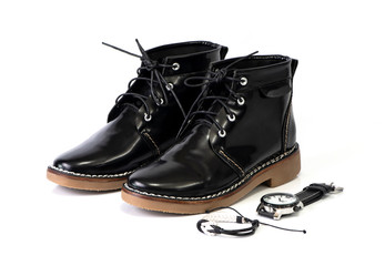 Men’s black boots and watch isolated on a white background.