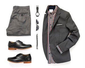 Men's clothing set with office shirt, gray suit, watch, sunglasses, bracelet, trousers and black shoe isolated on a white background, Top view
