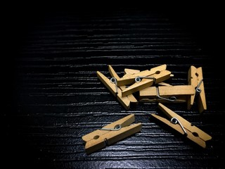 Wooden clothes pins on black wood board