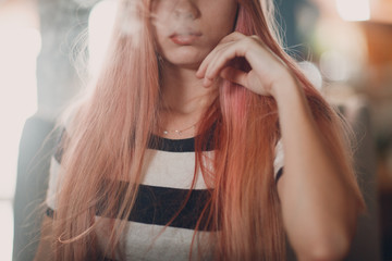 Fototapeta premium Young beautiful female smoking hookah. Smoke shisha hookah concept. Close up portrait.